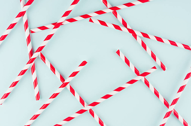 Abstract modern fashion background - red and white striped straws as random pattern on light mint background. - Fotó, kép