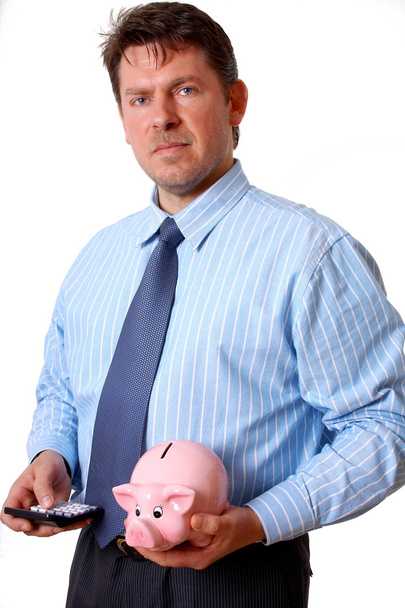 Businessman with calculator and pink piggy bank - Foto, imagen