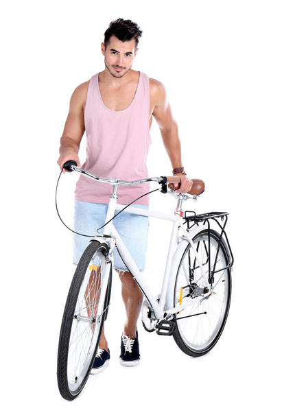 Handsome young hipster man with bicycle on white background - Valokuva, kuva