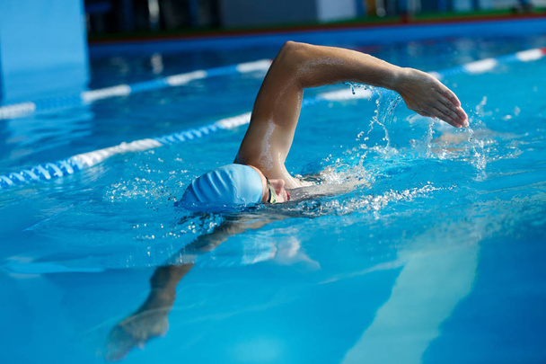 Image of sports man in blue cap swimming in pool - Fotografie, Obrázek