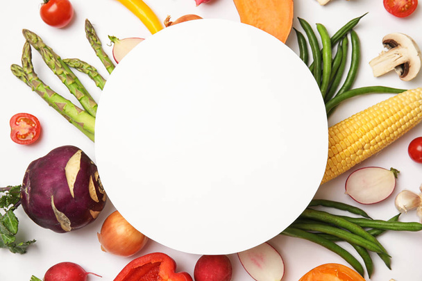 Flat lay composition with fresh vegetables and blank card for text on white background - Foto, Imagem