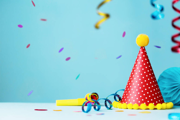 Colorful birthday party background with hat and streamers - Photo, Image