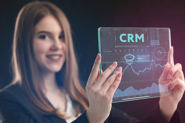 The concept of business, technology, the Internet and the network. A young entrepreneur working on a virtual screen of the future and sees the inscription: CRM - Фото, изображение