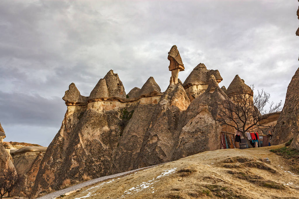 shaped rocks in beautiful Cappadocia landscape and cloudy sky  - Photo, image