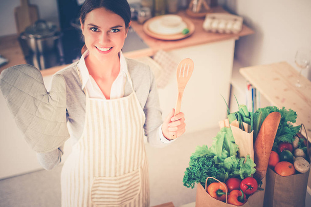 Woman making healthy food standing smiling in kitchen - Fotografie, Obrázek