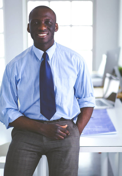 Portrait of an handsome black businessman standing in office - Fotó, kép