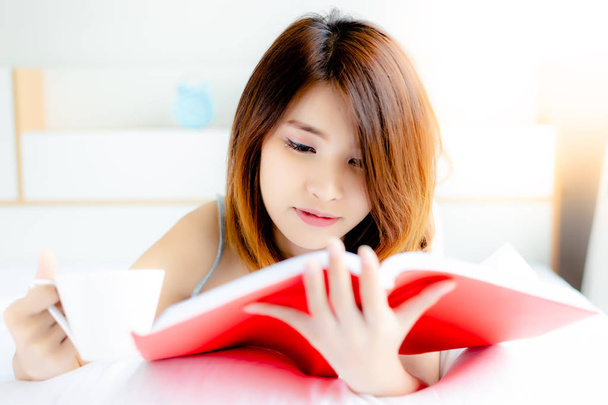 Attractive university student woman. Beautiful girl is reading textbook last night until morning because she will get examination this afternoon. Student girl has to drink coffee for getting fresh - Foto, afbeelding