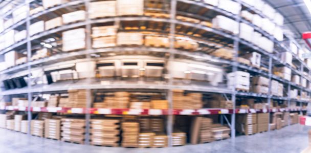 Panorama view blurred full-frame image aisles and bins at furniture warehouse in America. Defocused abstract industrial storehouse interior full of boxes, shelves, racks from floor to ceiling - Photo, Image