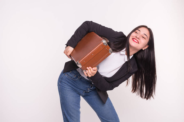 Young asian woman holding leather suitcase on white background - Φωτογραφία, εικόνα