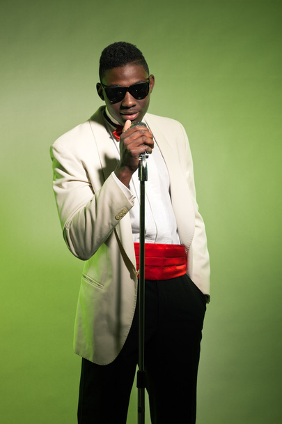 Singing black american man in suit wearing sunglasses. Vintage. - Фото, зображення