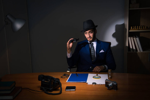 Detective sitting in dark room in vintage concept - Fotografie, Obrázek