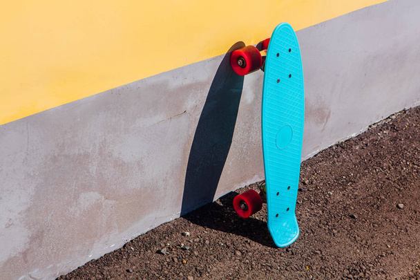 Blue plastic skateboard penny board with pink wheels. - Φωτογραφία, εικόνα