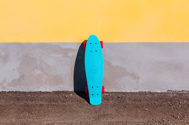 Blue plastic skateboard penny board with pink wheels. - Zdjęcie, obraz