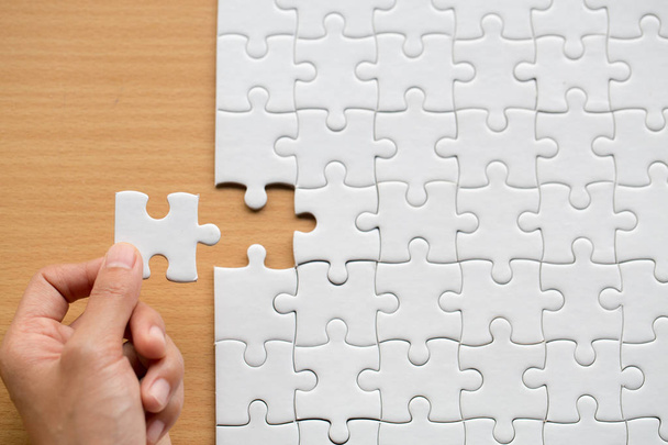 Hand put the last piece of jigsaw puzzle to complete the mission, Business solutions, success and strategy concept - Photo, Image