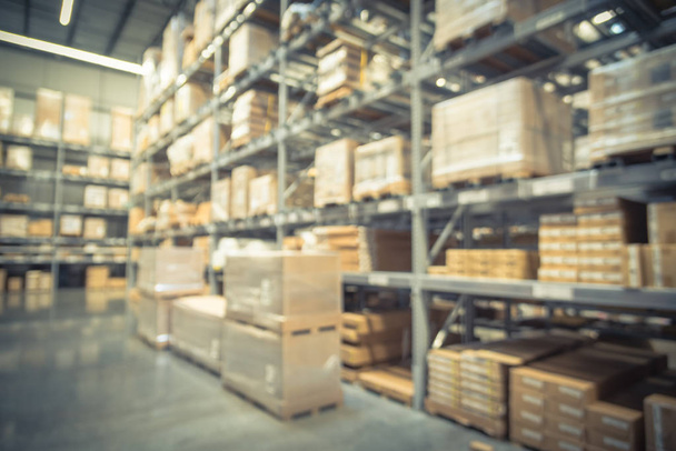 Abstract blurred large furniture warehouse with row of aisles and bins from floor to ceiling. Defocused background industrial storehouse inventory interior rack of big boxes home accessories - Photo, Image
