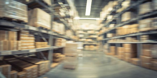 Panorama blurred large furniture warehouse with row of aisles and bins from floor to ceiling. Defocused background industrial storehouse inventory interior rack of big boxes home accessories - Photo, Image