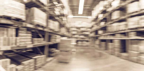 Vintage tone panorama blurred large furniture warehouse with row of aisles and bins from floor to ceiling. Defocused background industrial storehouse inventory interior rack of big boxes products - Photo, Image