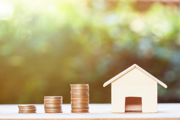 Property investment,  home loan, house mortgage, resident financial concept : Stacking coins in 1 to 3 step with small house on table over green nature background. Demonstrate growth of real estate. - Fotoğraf, Görsel
