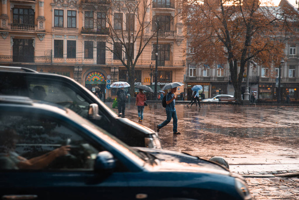 LVIV, UKRAINE - September 7, 2018: rain in city. people walking with umbrella. autumn is coming - Fotoğraf, Görsel