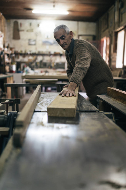 Close up shot of old master carpenter working in his woodwork or workshop - Φωτογραφία, εικόνα