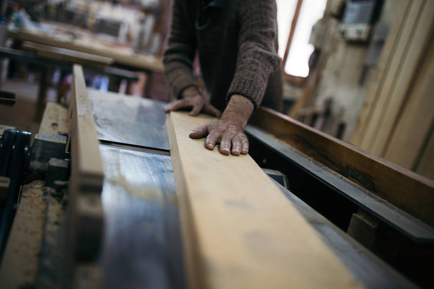 Close up shot of old master carpenter working in his woodwork or workshop - Fotografie, Obrázek