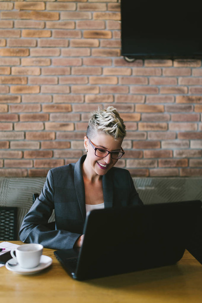 Young positive woman with glasses working in modern office.  - Foto, Imagen
