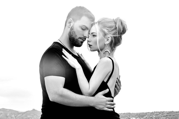 In love Eastern couple in mountains of Cappadocia hugs and kisses. Love and emotions loving couple vacationing in Turkey. Closeup portrait man and woman. Beautiful Crescent moon earrings on girl ears. - 写真・画像