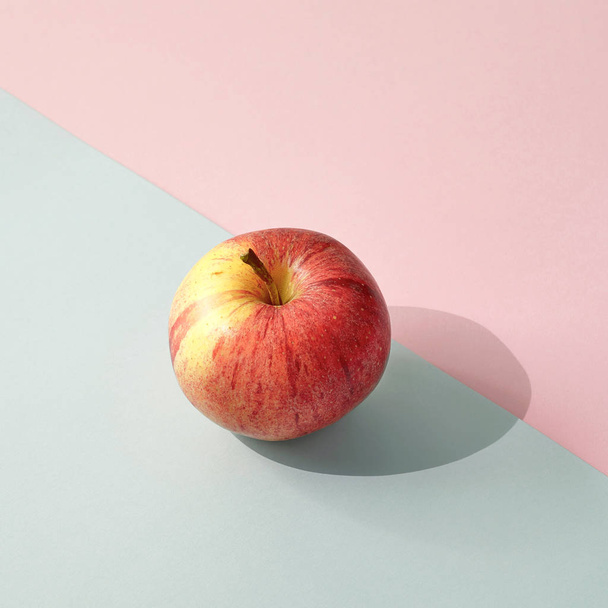 fresh ripe apple on colored paper background - Foto, Imagen