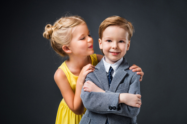 little stylish couple hugging and posing isolated on grey - Fotoğraf, Görsel
