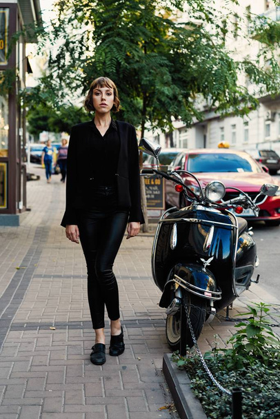 Young short haired woman in stylish black clothes posing               - Foto, Imagem
