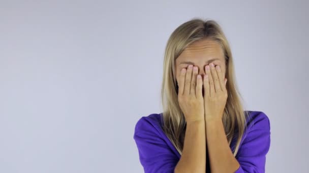 Girl rubs her eyes from fatigue against - Video
