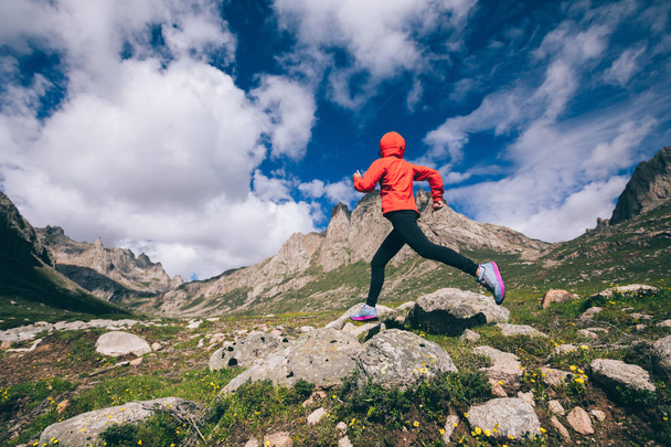 Woman trail runner running on beautiful mountains - Фото, зображення