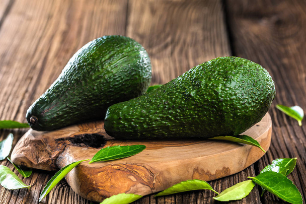 fresh avocados on wooden table, close up - Фото, изображение
