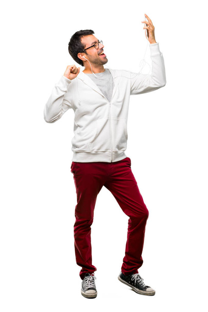 Full body of Man with glasses and listening music enjoy dancing while listening to music at a party on white background - Foto, Imagem