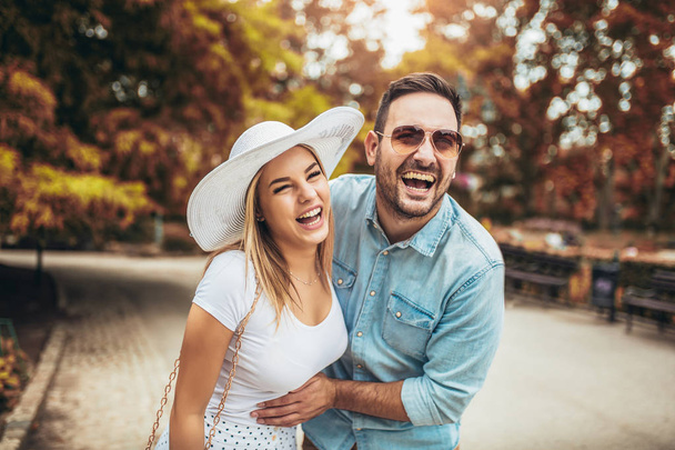 Cheerful young couple having fun and laughing together outdoors - Photo, Image