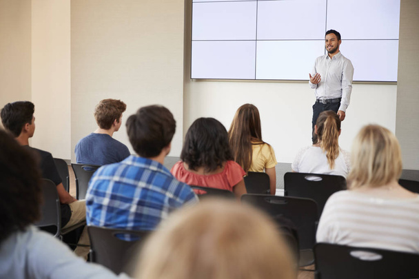 Teacher Giving Presentation To High School Class In Front Of Screen - Foto, Imagen