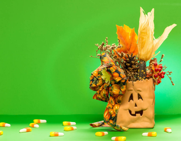 Halloween bag isolated with candy and a greeen background - Foto, imagen