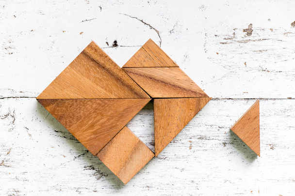 Rompecabezas Tangram en forma de corazón que esperan a cumplir o completar sobre fondo de madera blanca vieja
 - Foto, imagen