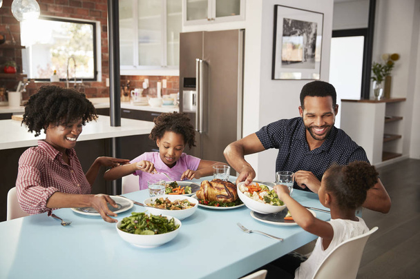 Family Enjoying Meal Around Table At Home Together - Foto, Imagem