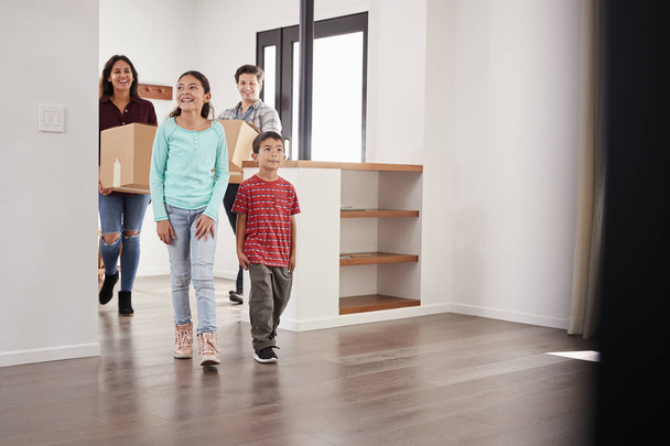 Excited Family Carrying Boxes Into New Home On Moving Day - Foto, imagen