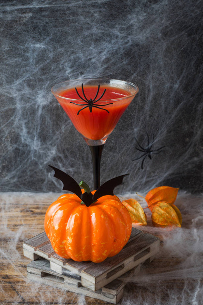 Bloody Mary cocktail, pumpkin with bats and spiders for Halloween, selective focus. - Fotoğraf, Görsel