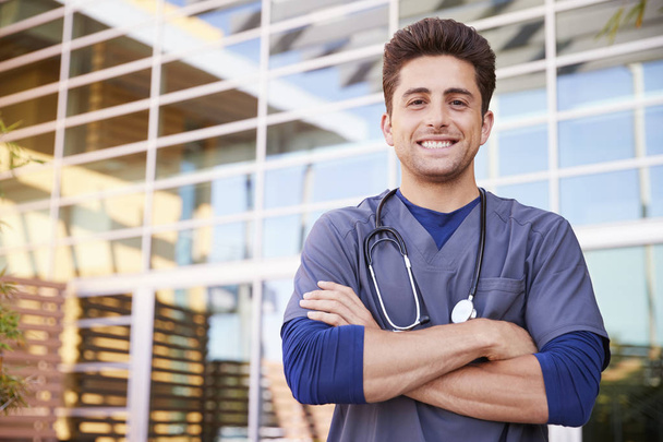Young Hispanic male healthcare worker outdoors - Фото, изображение