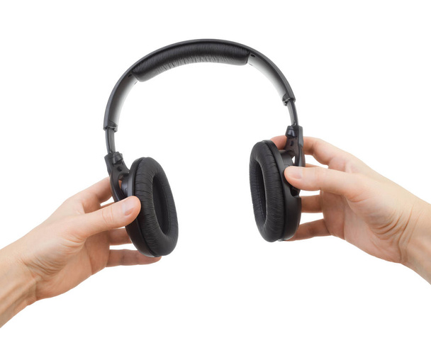 Ακουστικά στα χέρια σε λευκό φόντο - Φωτογραφία, εικόνα