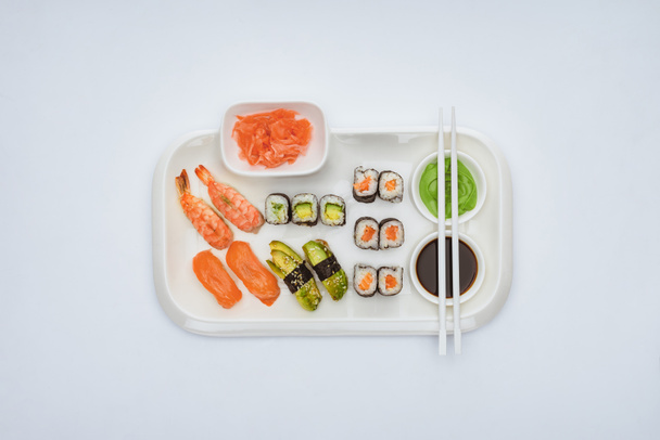 top view of delicious sushi set with chopsticks isolated on white  - Fotoğraf, Görsel