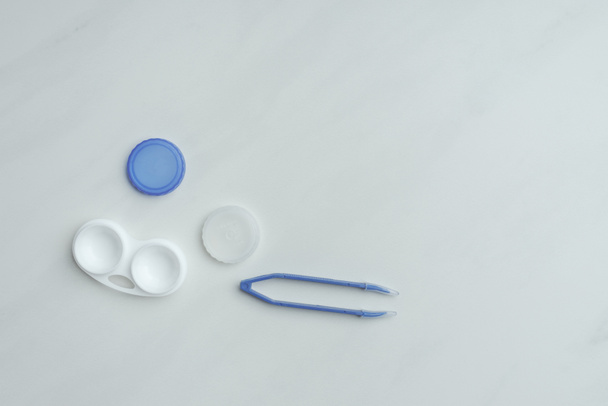 top view of contact lenses container and tweezers on white backdrop - Photo, Image