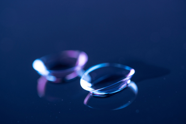 selective focus of contact lenses arranged on blue backdrop - Photo, Image