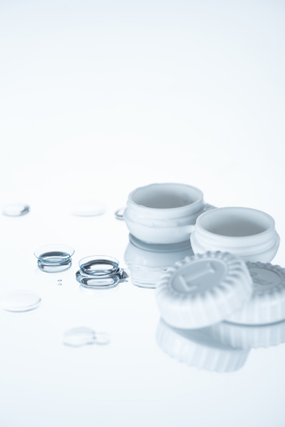 close up view of container and contact lenses on white backdrop - Photo, Image