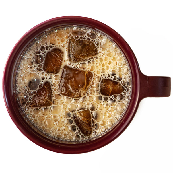 Milk coffee cocktail from frozen coffee cubes isolated on white background. top view. - Photo, Image