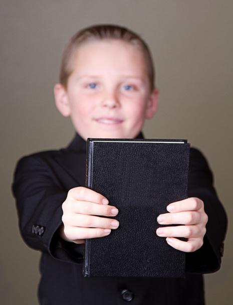 Boy holding book out - Fotoğraf, Görsel