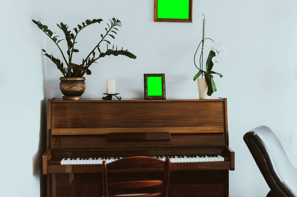 Old piano in a vintage interior with blank frames with copyspace - Photo, Image